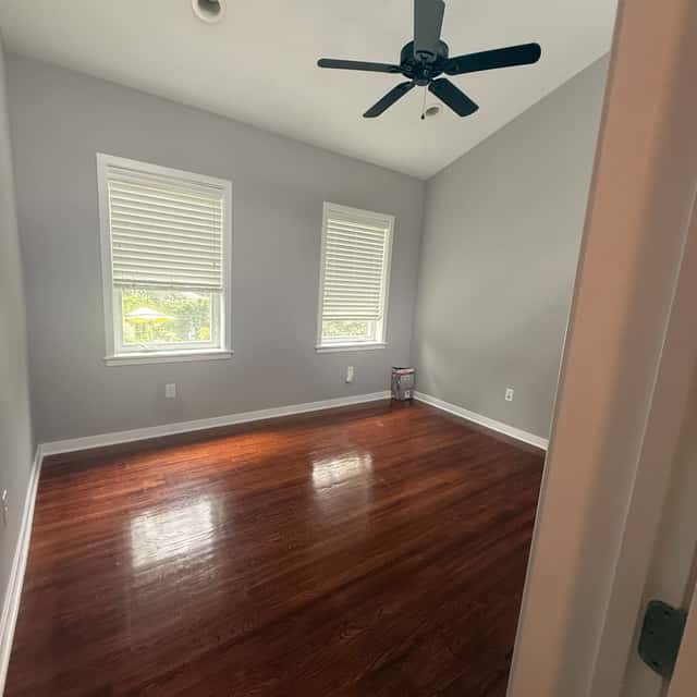 Bright vacant bedroom with gleaming hardwood floors, two windows and a ceiling fan — Perficient Deep Cleaning LLC, Philadelphia, PA